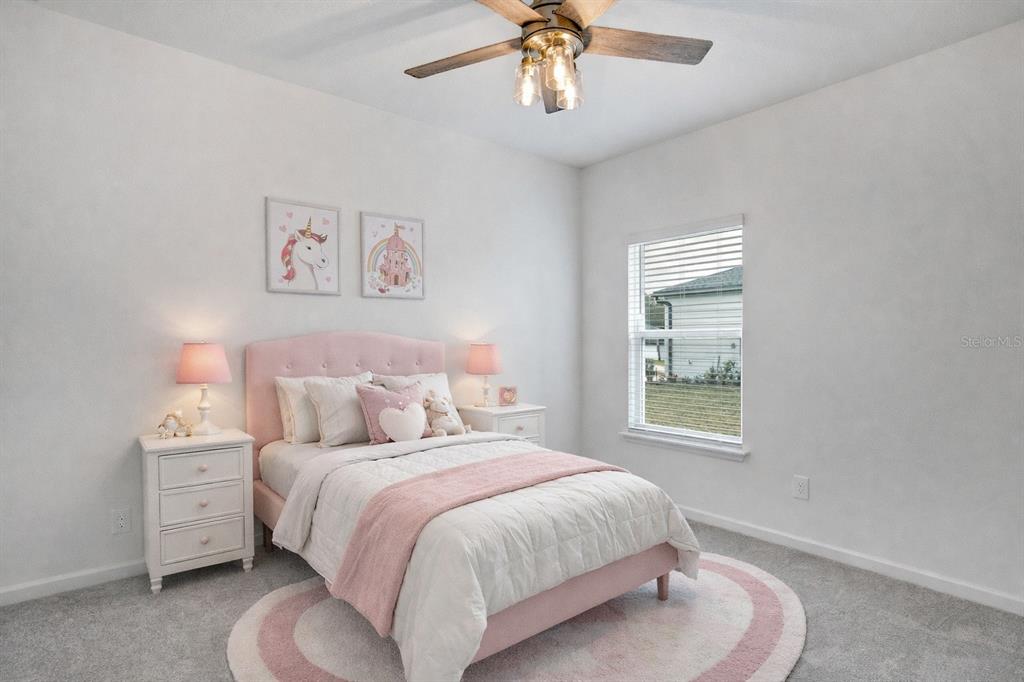 19438 Southwest 79th Street Dunnellon, FL 34432 - Photo 17 of 34 a bedroom with a bed and a chandelier
