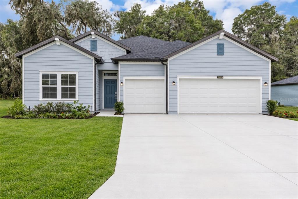 19438 Southwest 79th Street Dunnellon, FL 34432 - Photo 2 of 34 a front view of a house with a garden and yard