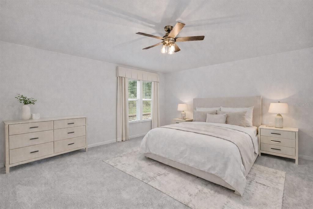 19438 Southwest 79th Street Dunnellon, FL 34432 - Photo 9 of 34 a bedroom with a bed and a chandelier fan