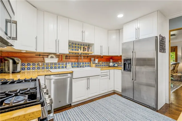 a spacious bathroom with a double vanity sink and a large mirror