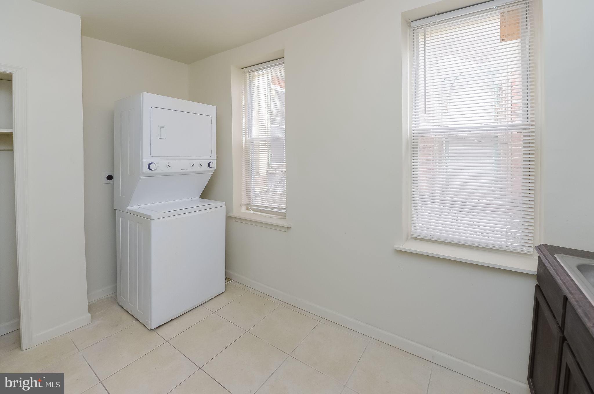 3733 North 15th Street, Unit 2 Philadelphia, PA 19140 - Photo 11 of 12 a utility room with a window dryer and washer