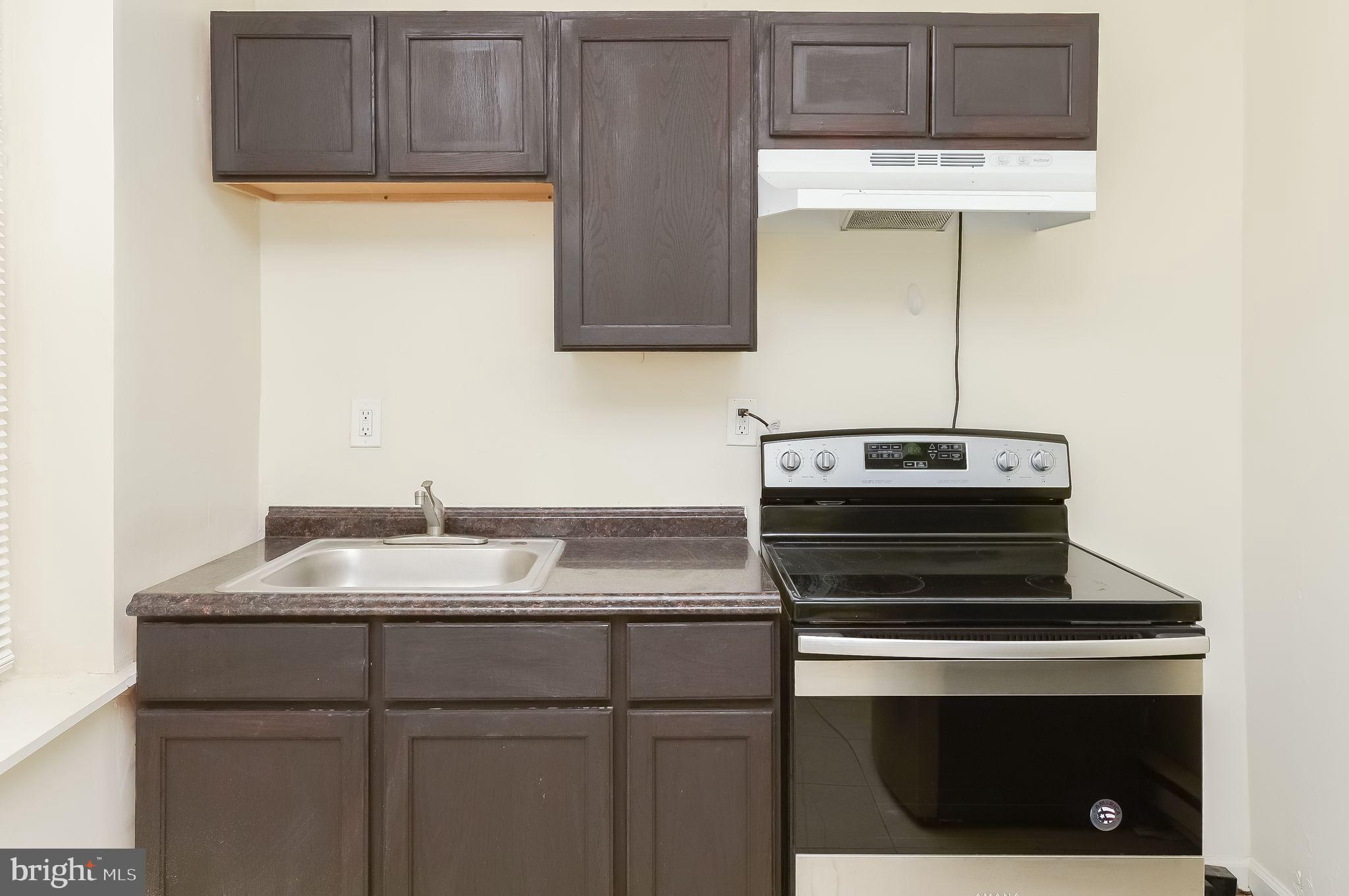 3733 North 15th Street, Unit 2 Philadelphia, PA 19140 - Photo 5 of 12 a kitchen with a stove and a sink