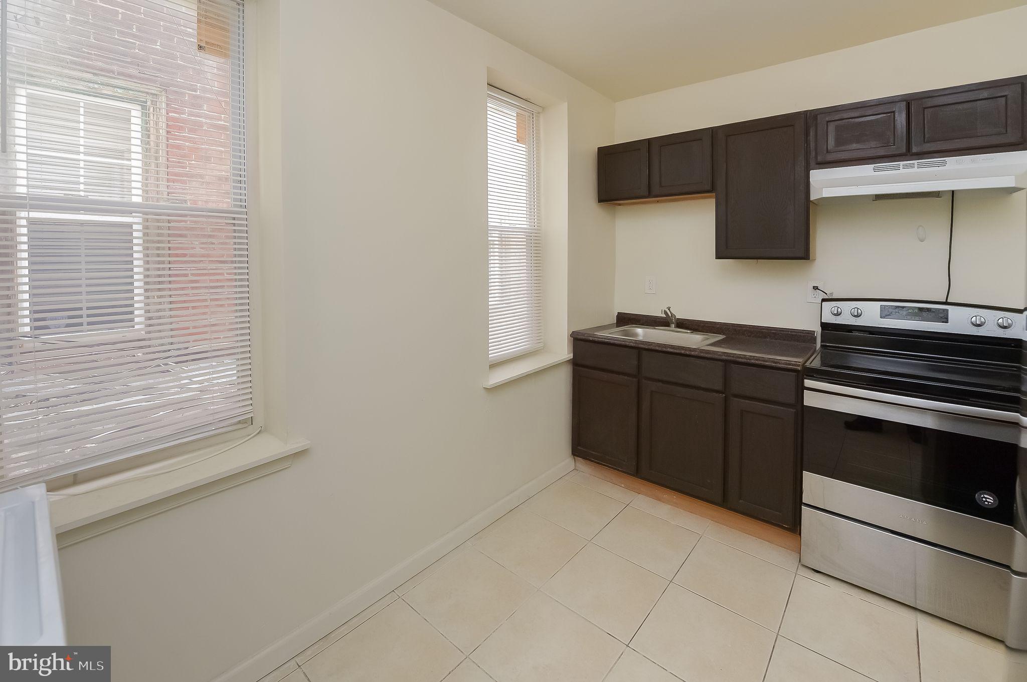 3733 North 15th Street, Unit 2 Philadelphia, PA 19140 - Photo 6 of 12 a kitchen with stainless steel appliances a sink and a microwave