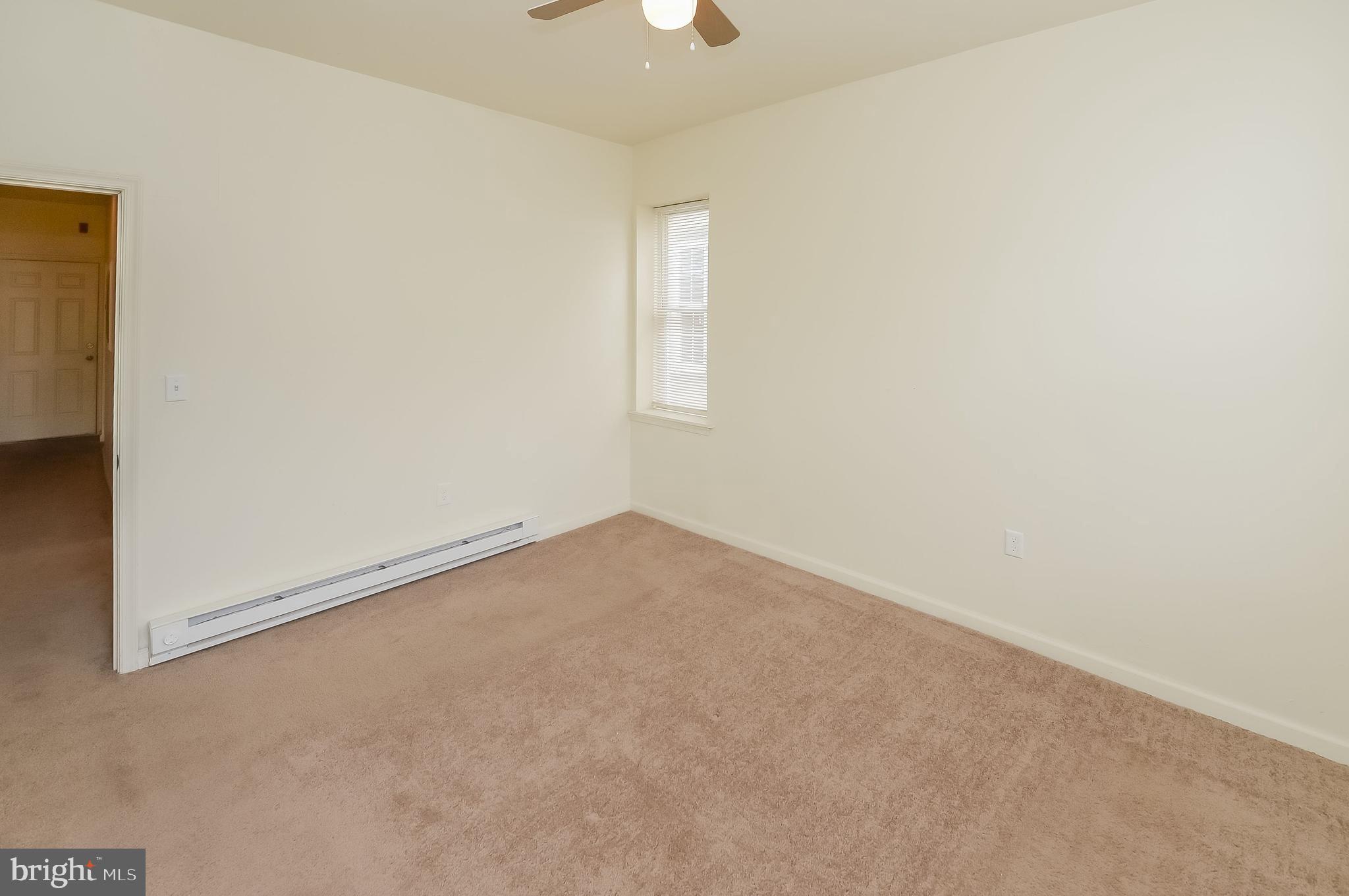 3733 North 15th Street, Unit 2 Philadelphia, PA 19140 - Photo 9 of 12 an empty room with a empty space and windows