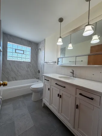 a bathroom with a double vanity sink and a bathtub