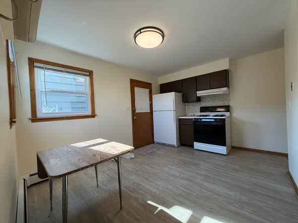 a kitchen with stainless steel appliances granite countertop a refrigerator and a stove top oven