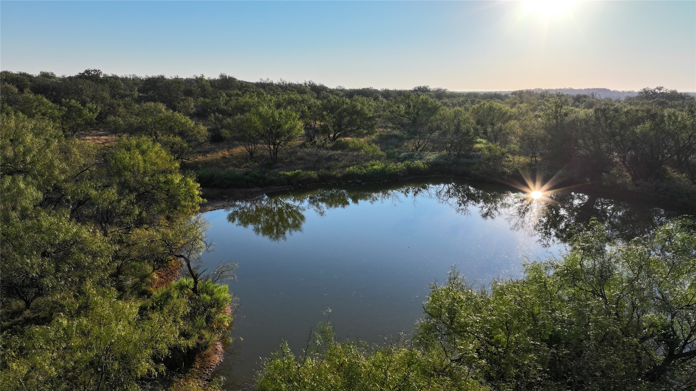 392 County Road 230 San Saba, TX 76877 - Photo 13 of 40 a view of a lake with a mountain in the background