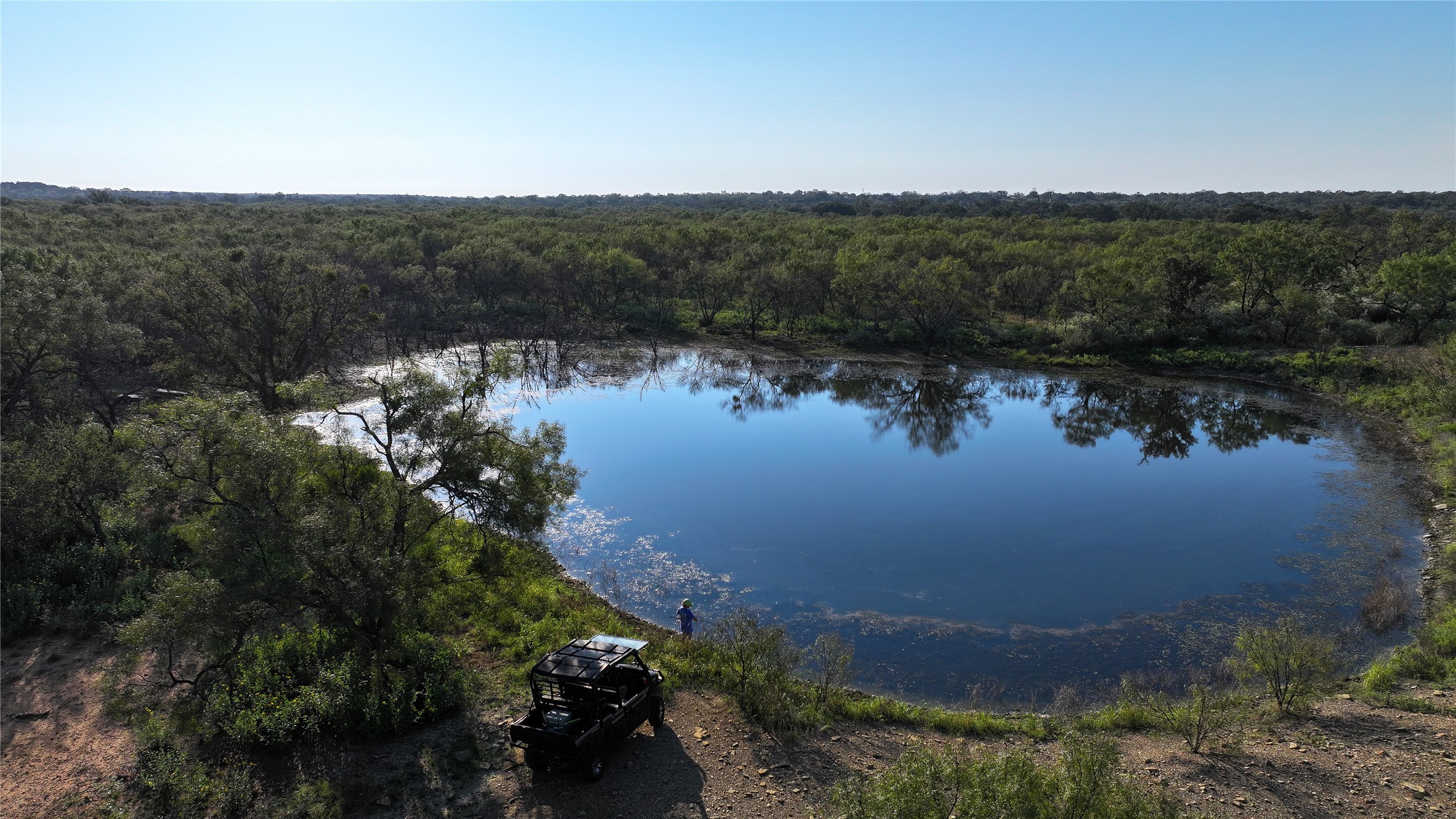 392 County Road 230 San Saba, TX 76877 - Photo 2 of 40 a view of a lake in middle of forest