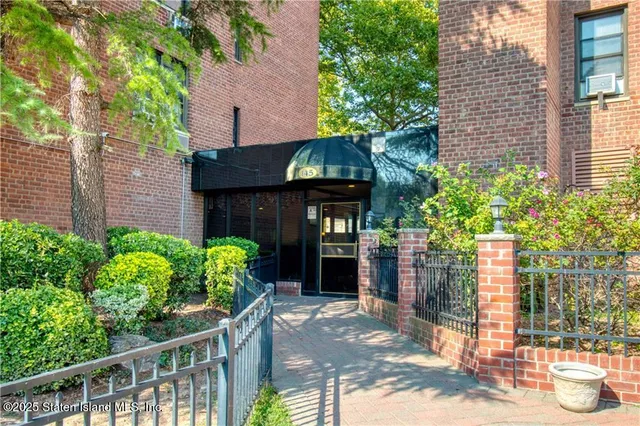 a front view of a house with plants