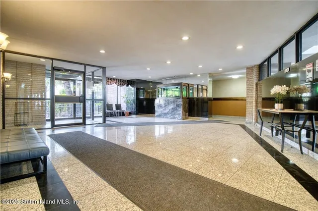 a view of a kitchen with a dining table chairs wooden floor and a large window