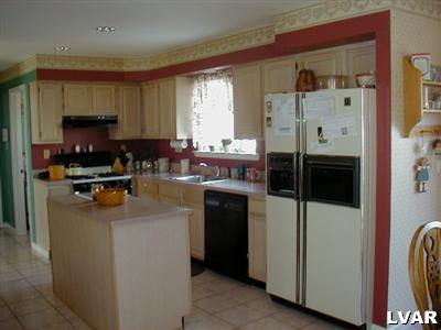 4985 Harvey Road Bethlehem, PA 18020 - Photo 2 of 8 Large expanded kitchen with center island, correl countertops, pantry. Breakfast nook is to the right and is open to the vaulted family room.