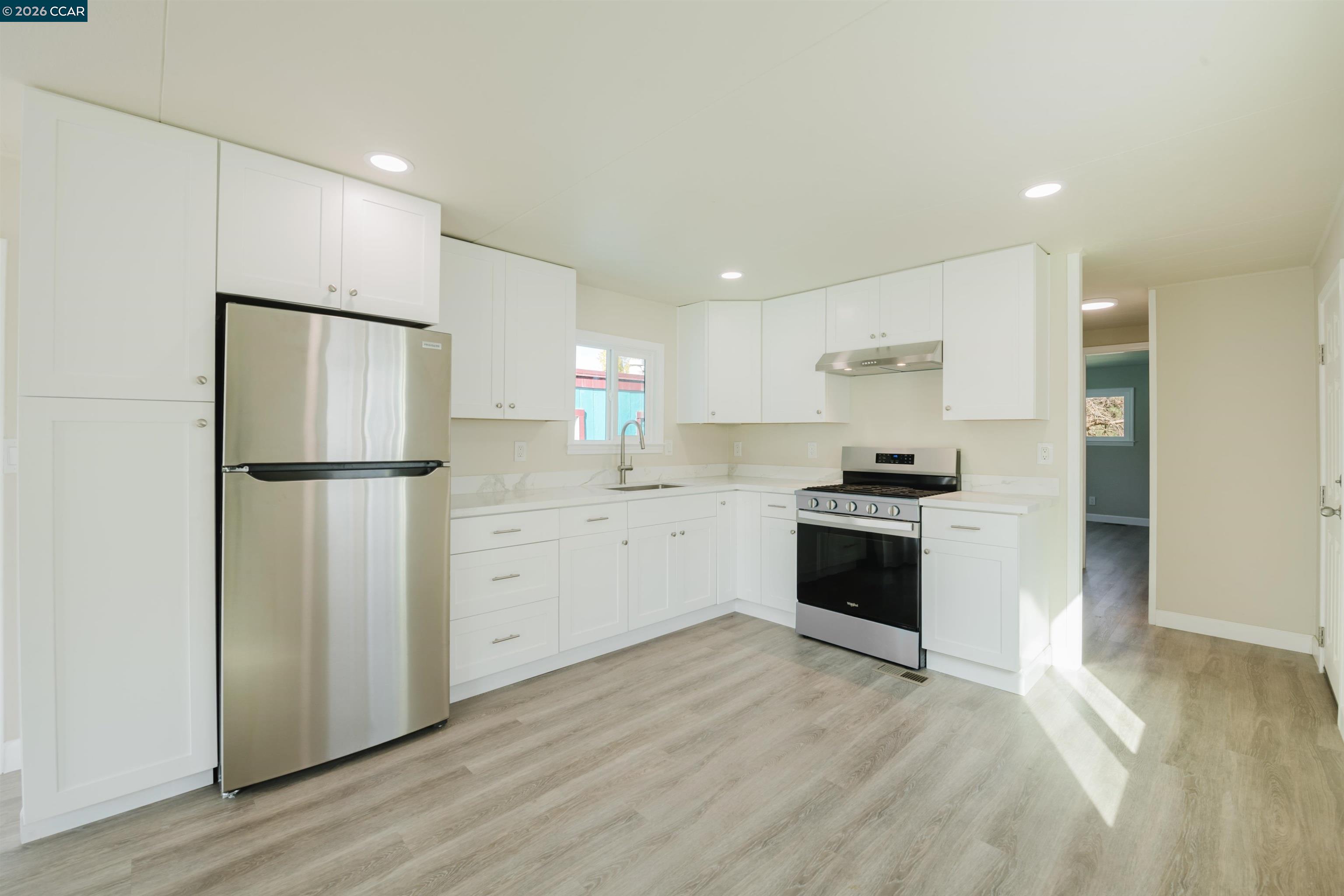 2990 San Pablo Dam Road, Unit 2 San Pablo, CA 94803 - Photo 40 of 41 a kitchen with white cabinets and stainless steel appliances
