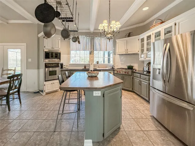 a kitchen with stainless steel appliances granite countertop a sink a stove and refrigerator