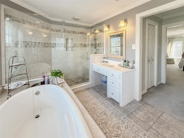 a bathroom with a tub sink and mirror