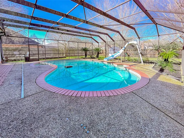 a view of a swimming pool with a patio