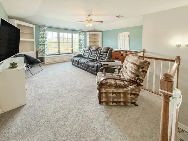 a bedroom with furniture and a flat screen tv