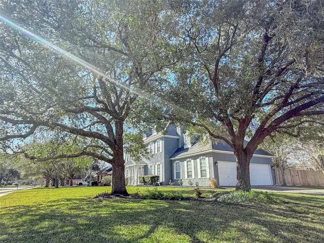 a front view of house with yard and trees