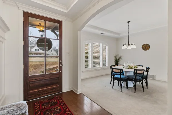 a view of a dining room with furniture wooden floor and chandelier