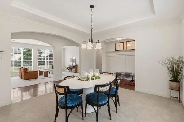 a living room with furniture and floor to ceiling window