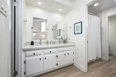 a bathroom with a double vanity sink and mirror