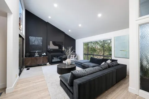 a living room with furniture tv and a large window