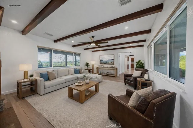a view of a livingroom with a ceiling fan and window