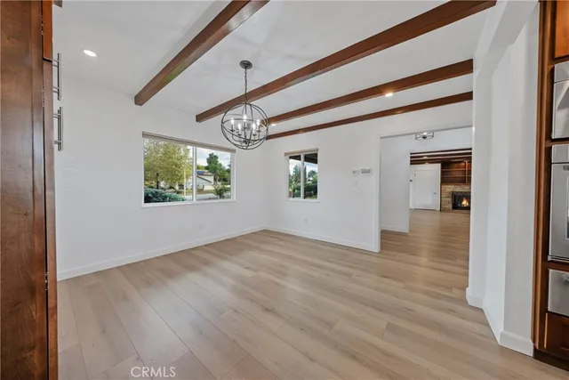 a bathroom with a granite countertop sink a mirror and a bathtub