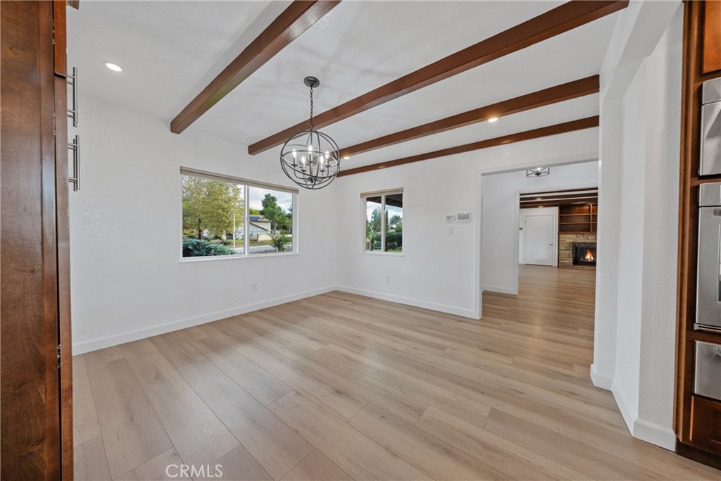 12646 10th Street Yucaipa, CA 92399 - Photo 15 of 72 a view of an empty room with wooden floor and a window
