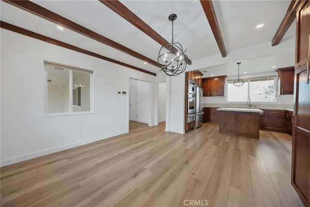 a bathroom with a granite countertop sink a mirror and shower