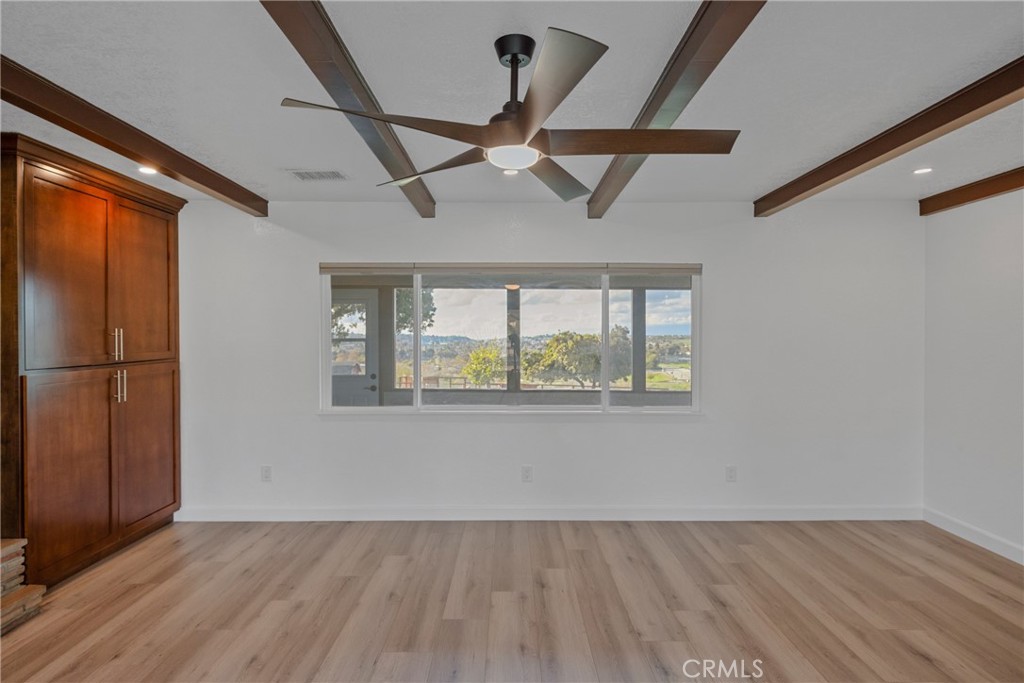 12646 10th Street Yucaipa, CA 92399 - Photo 23 of 72 a view of an empty room with wooden floor and a window