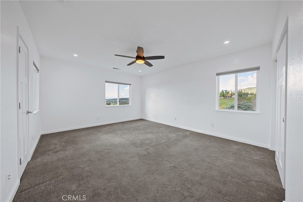 12646 10th Street Yucaipa, CA 92399 - Photo 25 of 72 a view of a livingroom with a ceiling fan and window