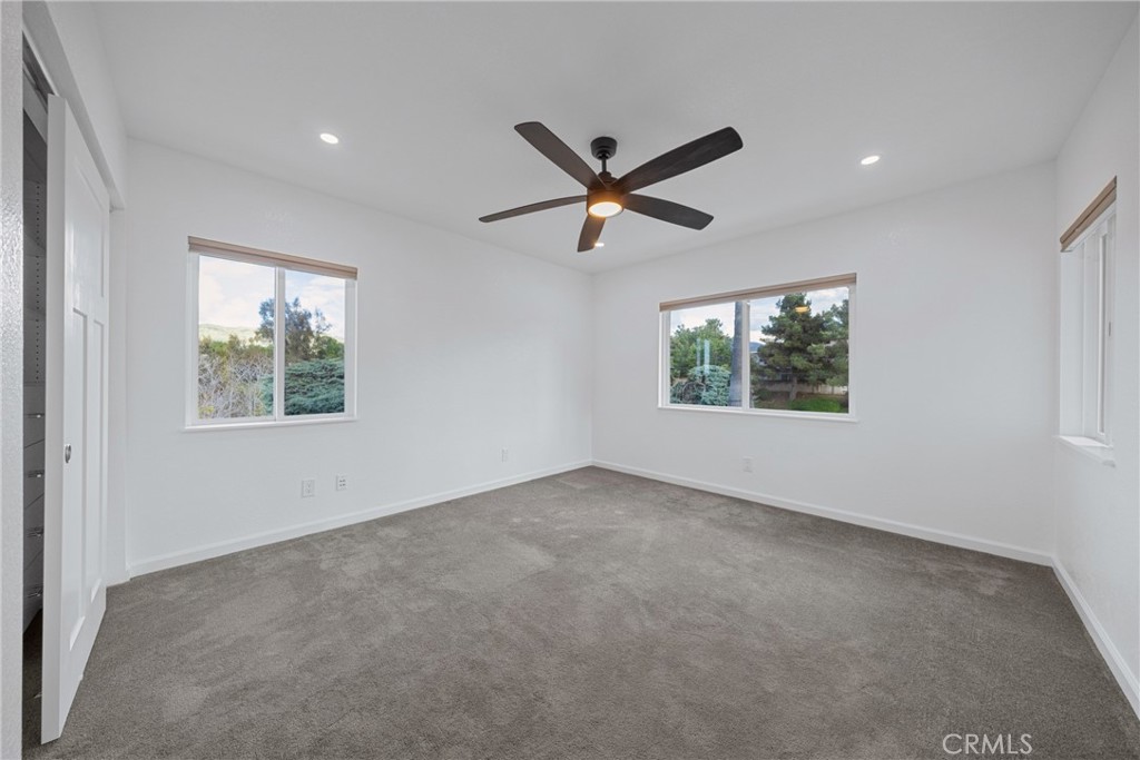 12646 10th Street Yucaipa, CA 92399 - Photo 28 of 72 an empty room with a window and a ceiling fan