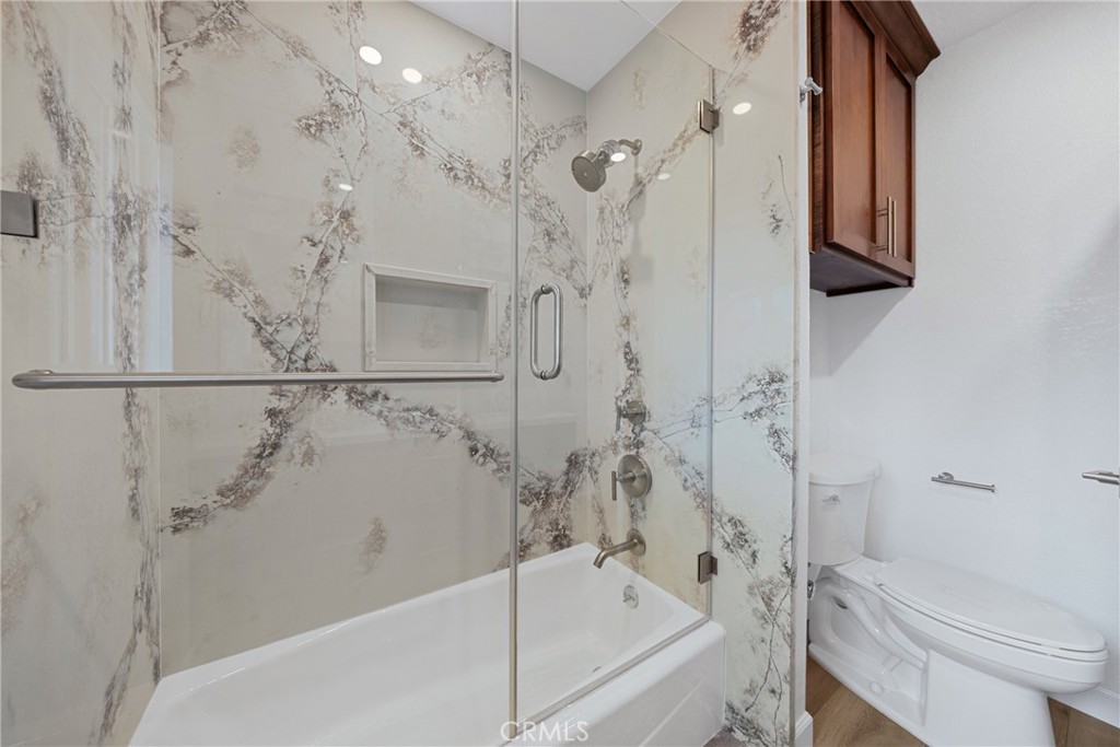 12646 10th Street Yucaipa, CA 92399 - Photo 32 of 72 a bathroom with a bathtub a toilet and a shower