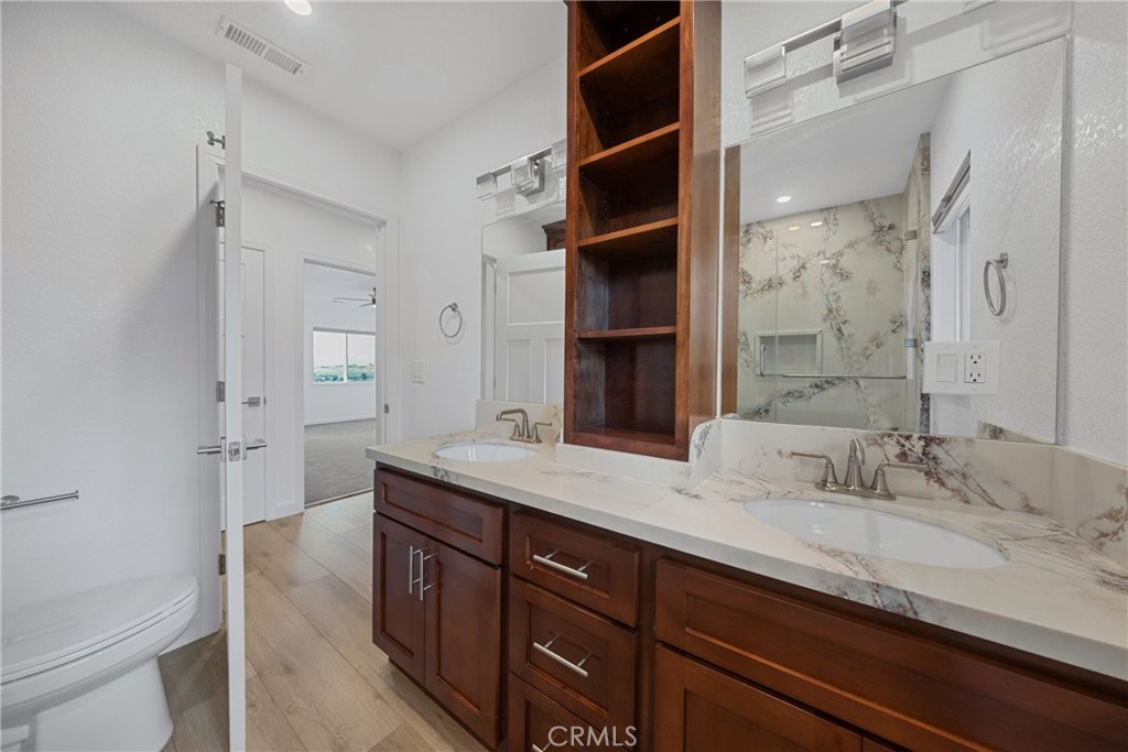 12646 10th Street Yucaipa, CA 92399 - Photo 33 of 72 a bathroom with a granite countertop sink a mirror and a bathtub