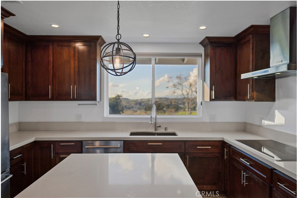 12646 10th Street Yucaipa, CA 92399 - Photo 43 of 72 a kitchen with stainless steel appliances granite countertop a sink a stove and a microwave