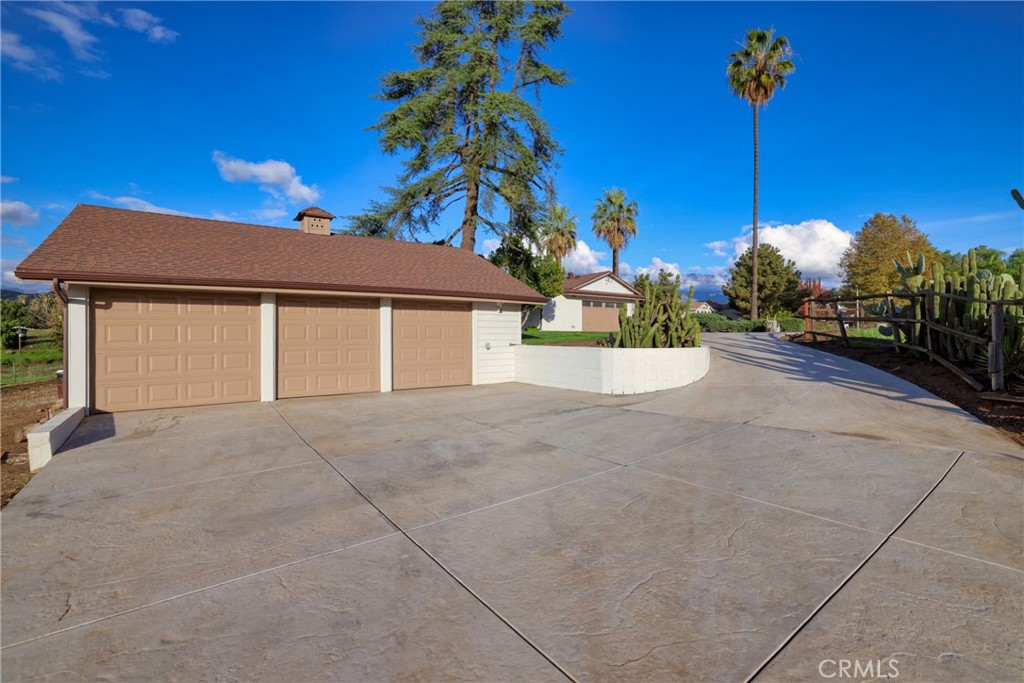 12646 10th Street Yucaipa, CA 92399 - Photo 50 of 72 a view of a house with a backyard and a garage