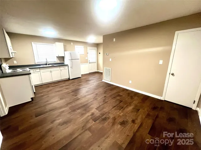 a view of a kitchen with wooden floor