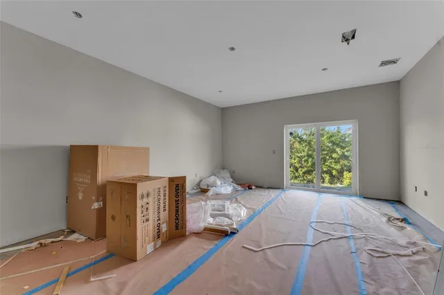 a bedroom with a bed and a flat tv screen