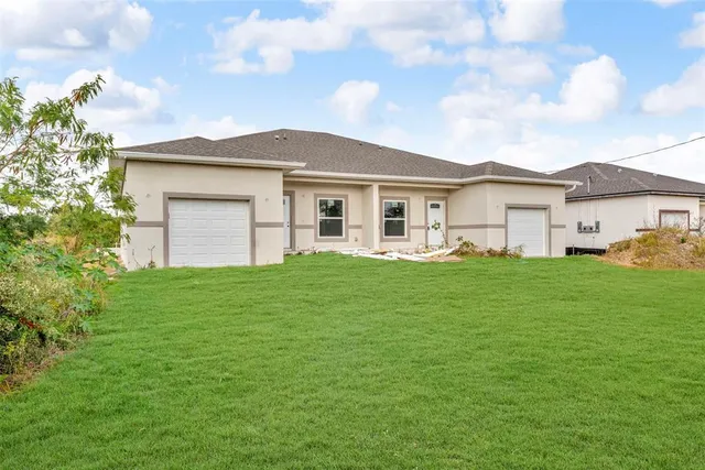 a front view of house with yard and green space