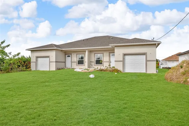 a view of a house with a backyard