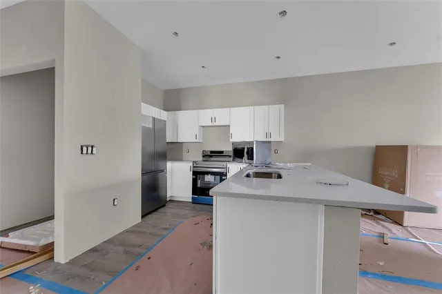a kitchen with a sink stove and refrigerator