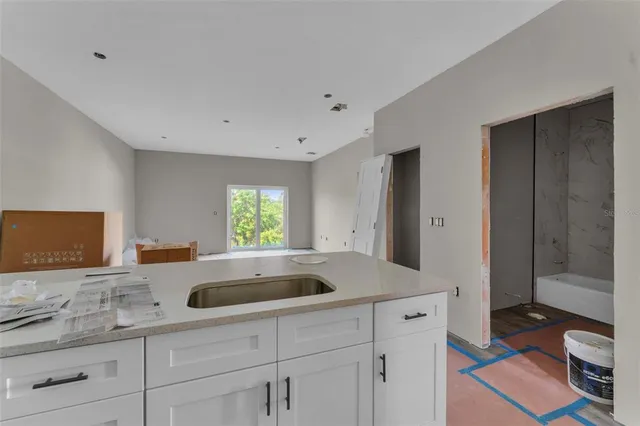 a kitchen with stainless steel appliances granite countertop a sink and a wooden cabinets