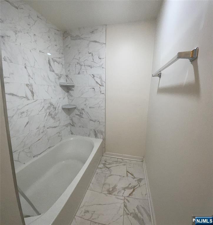 60 Passaic Street Garfield, NJ 07026 - Photo 13 of 14 a bathroom with a bathtub
