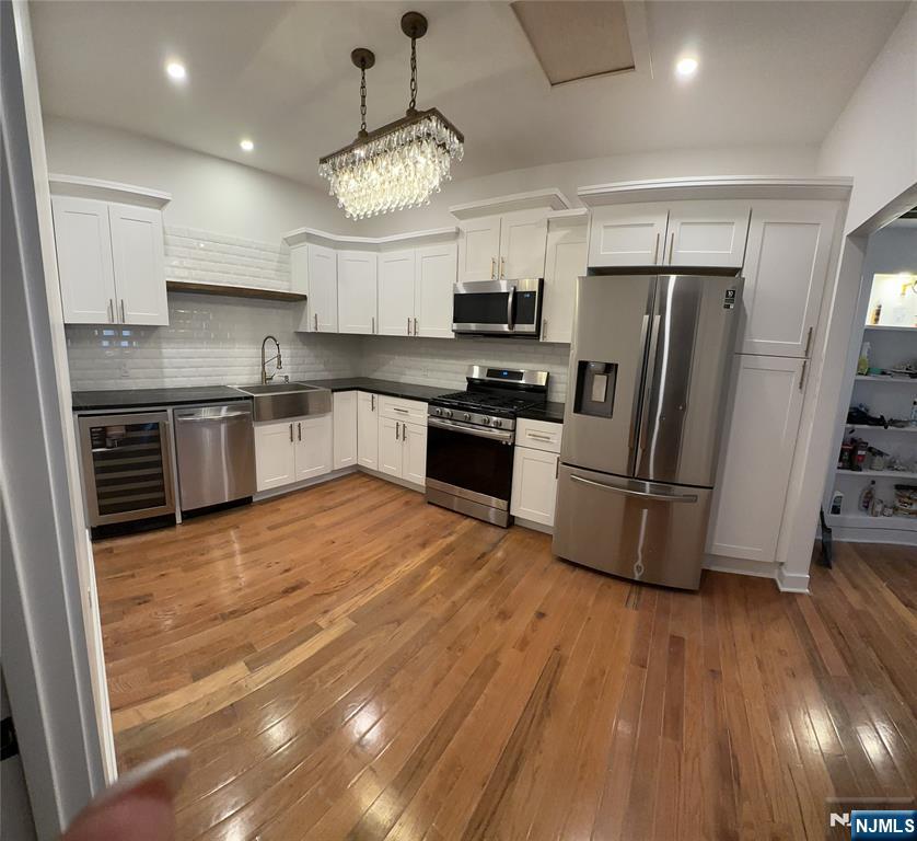 60 Passaic Street Garfield, NJ 07026 - Photo 2 of 14 a large kitchen with stainless steel appliances granite countertop a stove a refrigerator a sink dishwasher and a oven with wooden floor