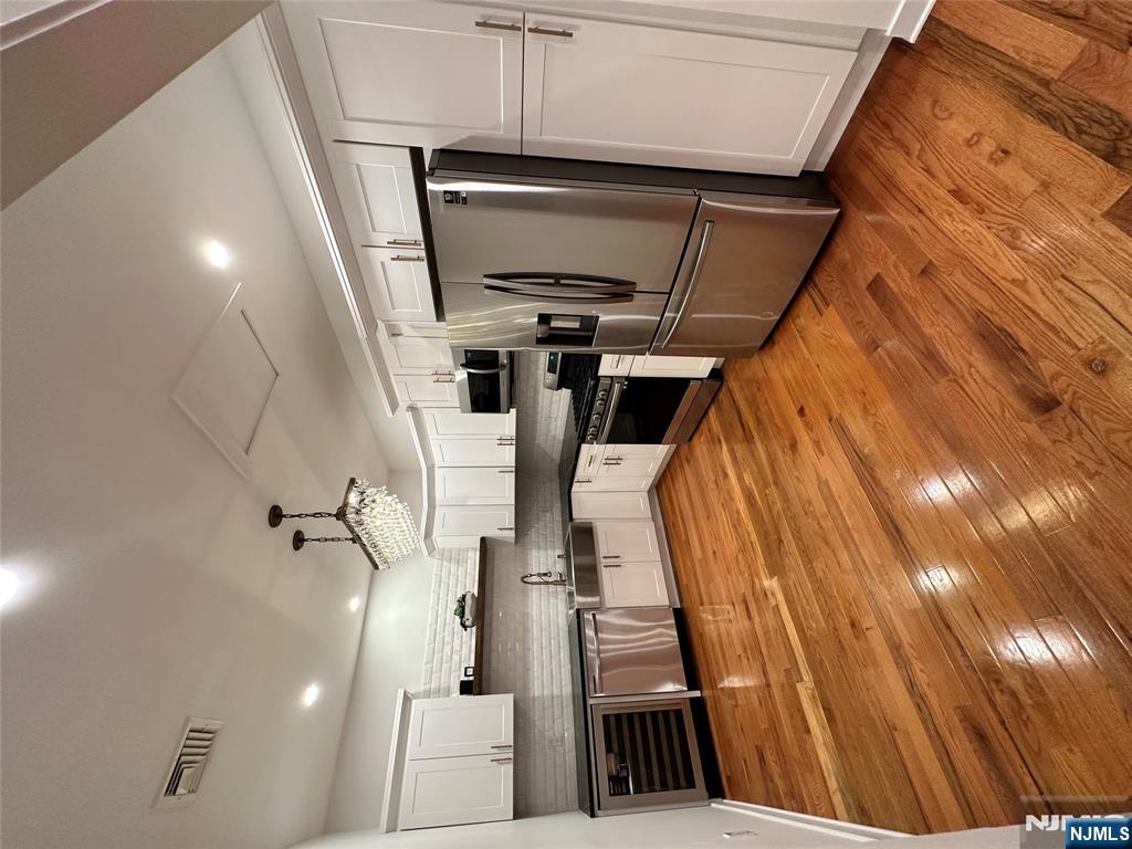 60 Passaic Street Garfield, NJ 07026 - Photo 3 of 14 a kitchen with stainless steel appliances a refrigerator and a stove top oven