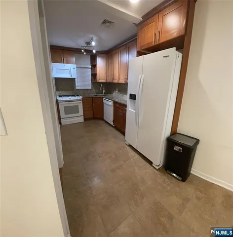 a kitchen with a refrigerator a stove and a microwave