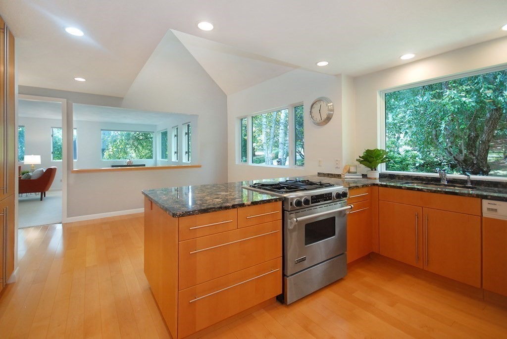 18 Washington Drive Acton, MA 01720 - Photo 11 of 29 a kitchen with stainless steel appliances granite countertop a stove a sink and a refrigerator