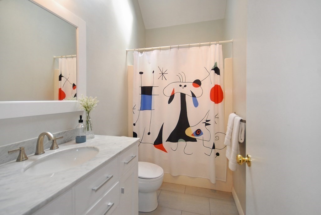 18 Washington Drive Acton, MA 01720 - Photo 20 of 29 a bathroom with a granite countertop sink and a toilet