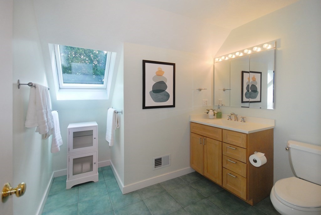 18 Washington Drive Acton, MA 01720 - Photo 25 of 29 a bathroom with a toilet sink and mirror