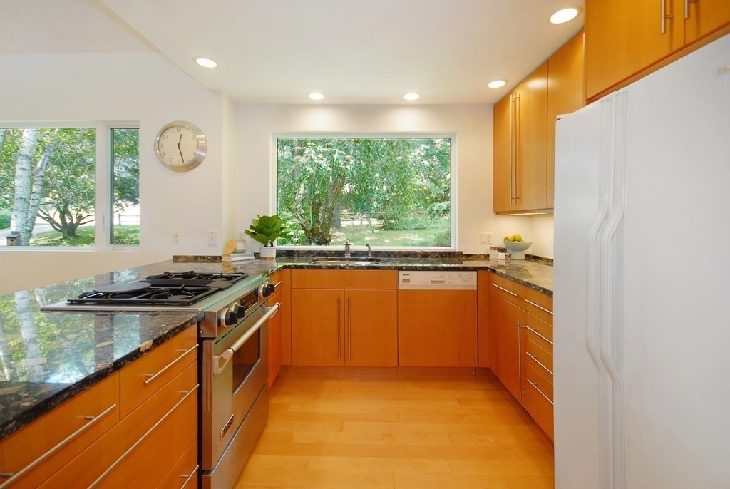 18 Washington Drive Acton, MA 01720 - Photo 9 of 29 a kitchen with stainless steel appliances granite countertop a stove a sink and a microwave